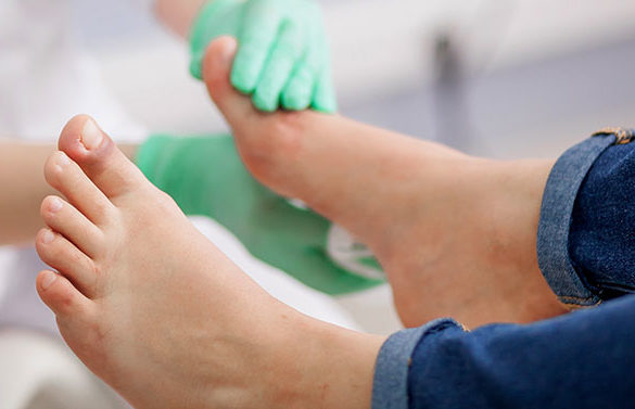 podiatrist examines foot