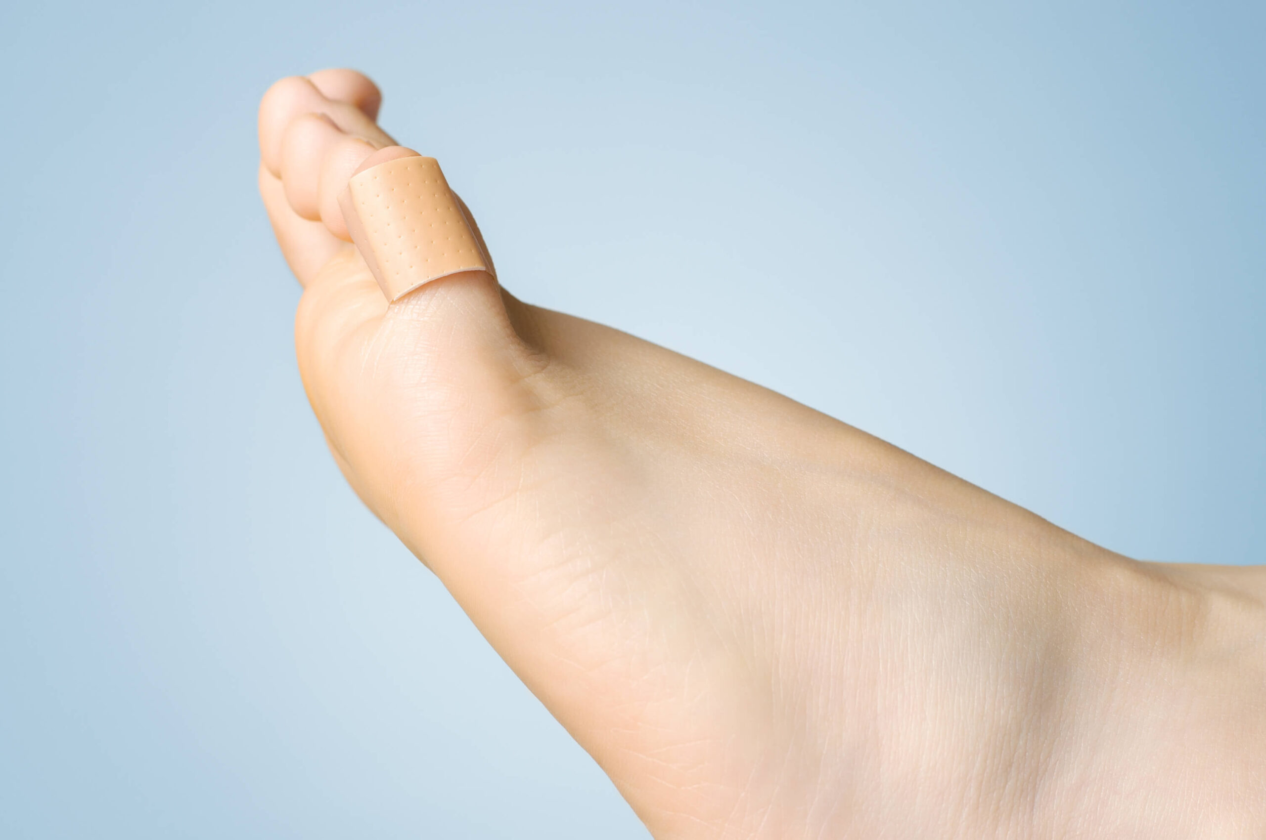 Closeup of a plaster on female toe